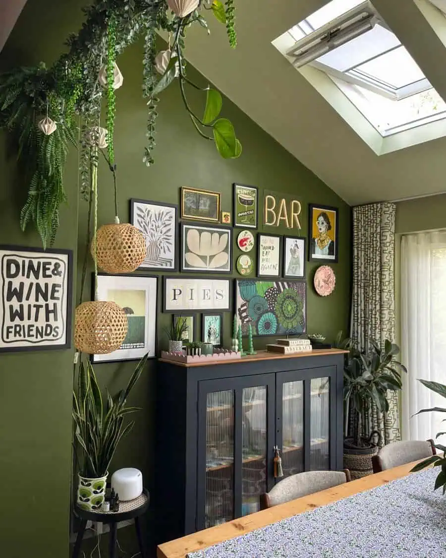 Eclectic gallery wall with greenery, bar sign, and artwork in a cozy dining room with skylight.