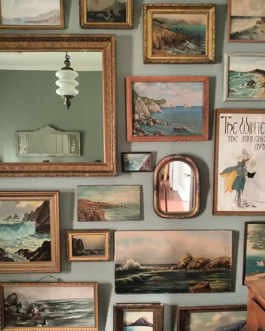 Vintage artwork gallery wall featuring seascape paintings and an ornate mirror.