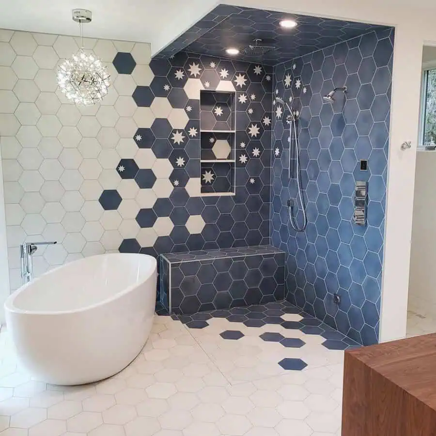 Walk-in shower with blue and white hexagon tiles, star patterns, and a freestanding bathtub.