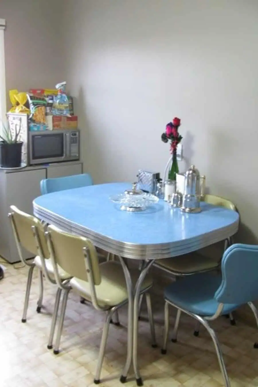 Chrome dining set with a light blue Formica tabletop and matching chairs, capturing a classic 1950s retro kitchen aesthetic.