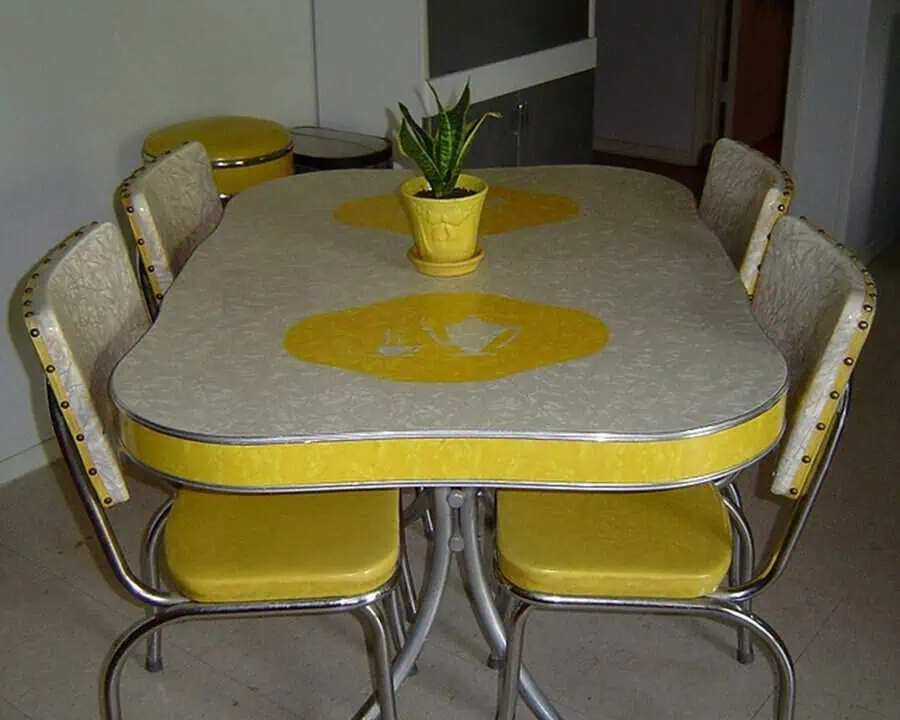 1950s yellow Formica kitchen dinette set with chrome trim and retro-style chairs.