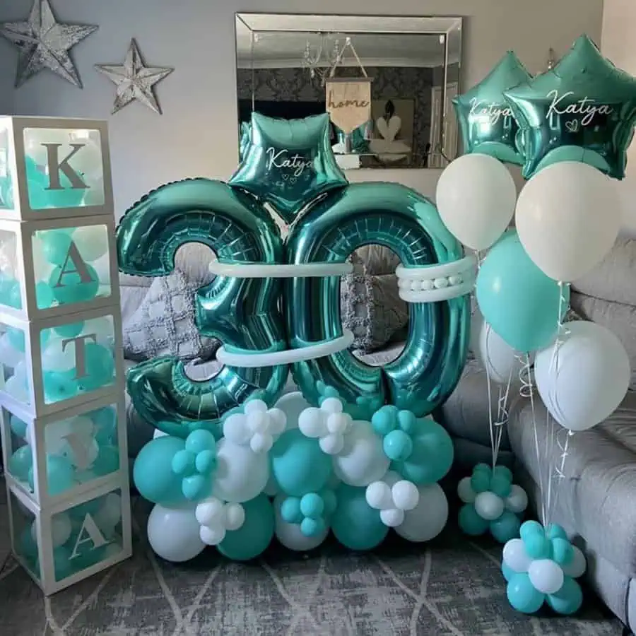 eal and white personalized balloon decor with "30" and name details for a birthday party.