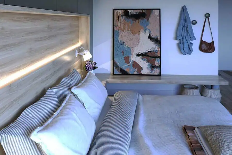 Modern bedroom with wooden headboard, ambient lighting, and abstract wall art.