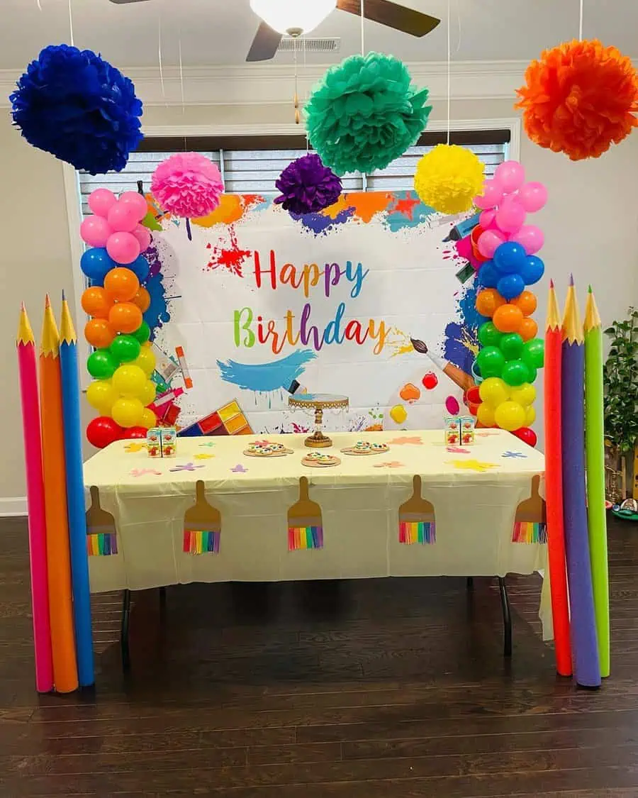 Art-themed kids' birthday party with colorful decorations, oversized pencils, and a painting-inspired table setup.