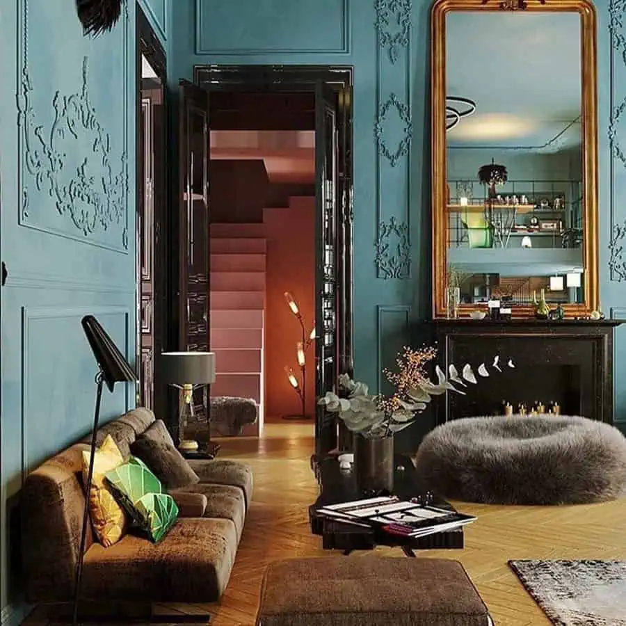 Sophisticated living room with teal walls, black accents, gold-framed mirror, and warm brown furniture.