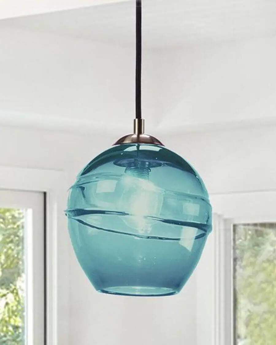 Bold teal pendant light with a sleek glass finish, ideal for a modern living room centerpiece.