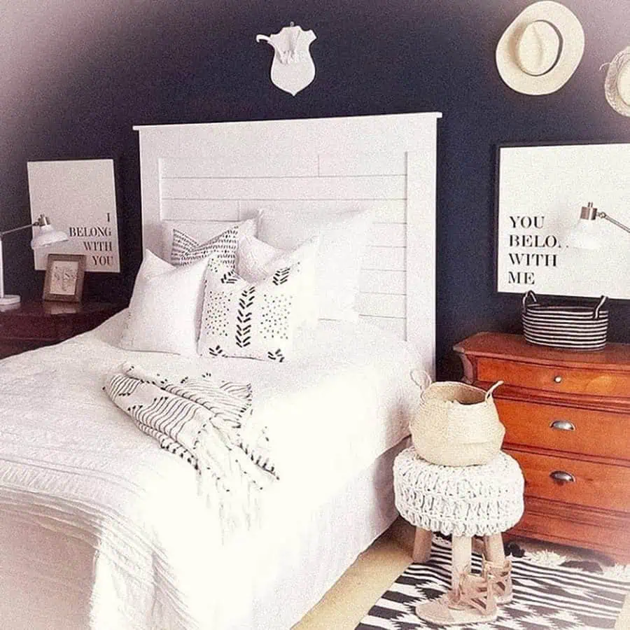 Modern bedroom with white shiplap headboard, rustic decor, and romantic wall quotes.