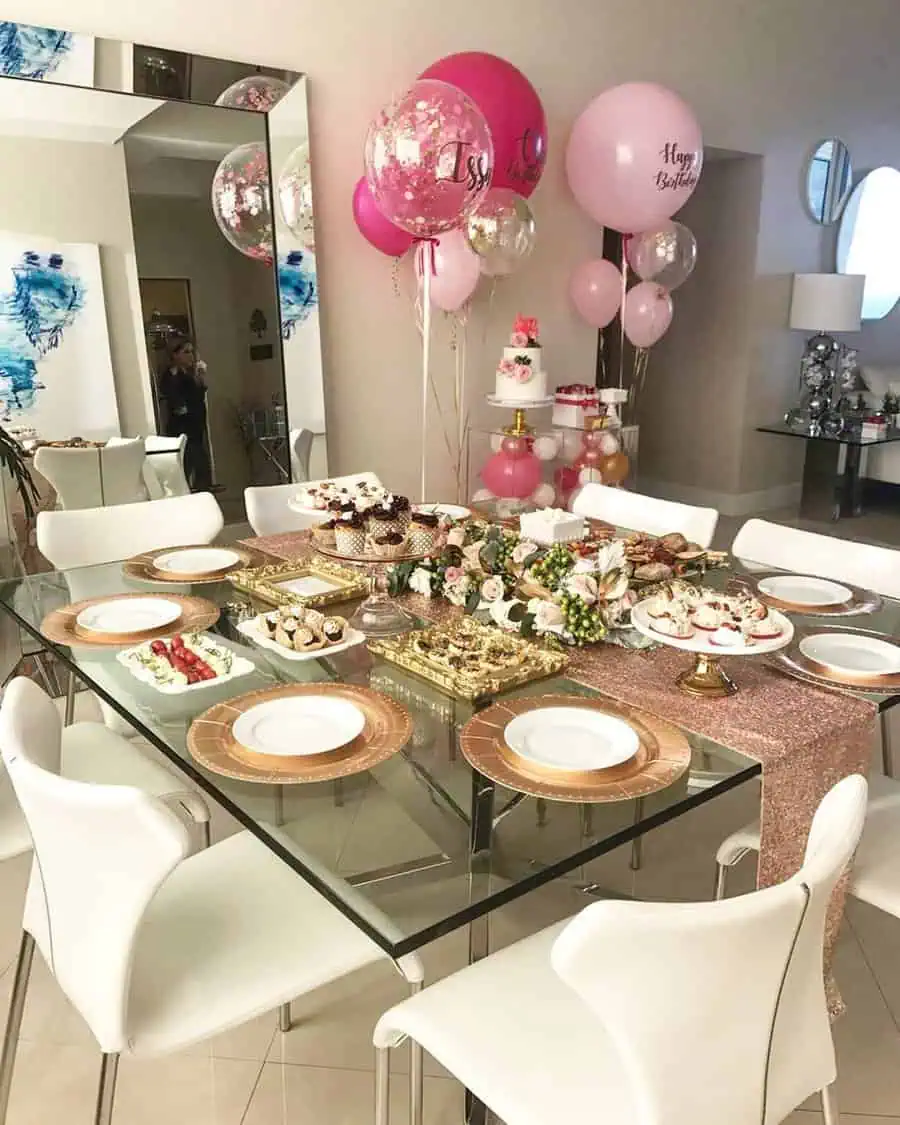 Chic birthday party with elegant pink and gold decor, balloons, and a stylish setup.