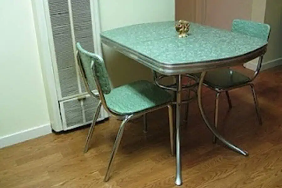 Retro chrome dining set with a green Formica table and matching chairs, perfect for a 1950s-style kitchen.