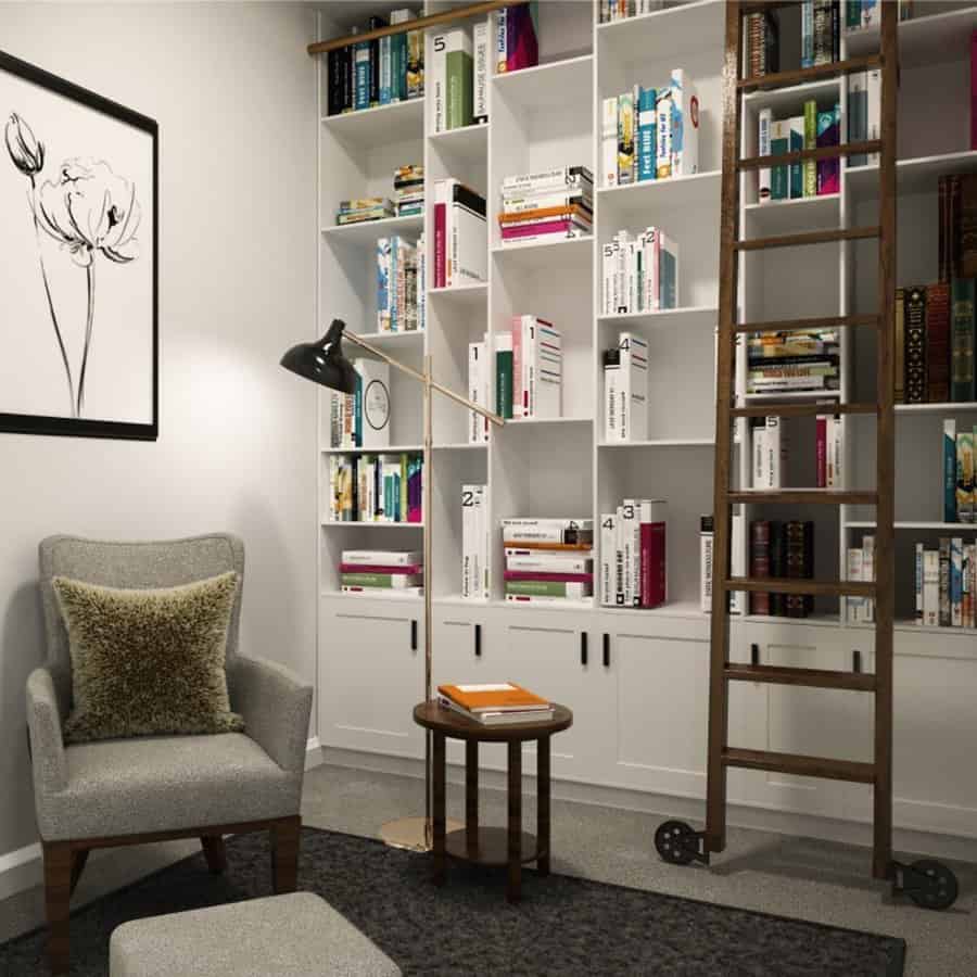 Cozy nook with built-in bookshelves, rolling ladder, armchair, and modern floor lamp.