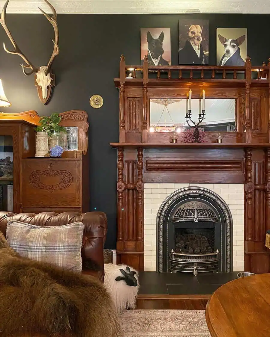 Traditional living room with antique fireplace, dark walls, animal decor, and vintage furniture.