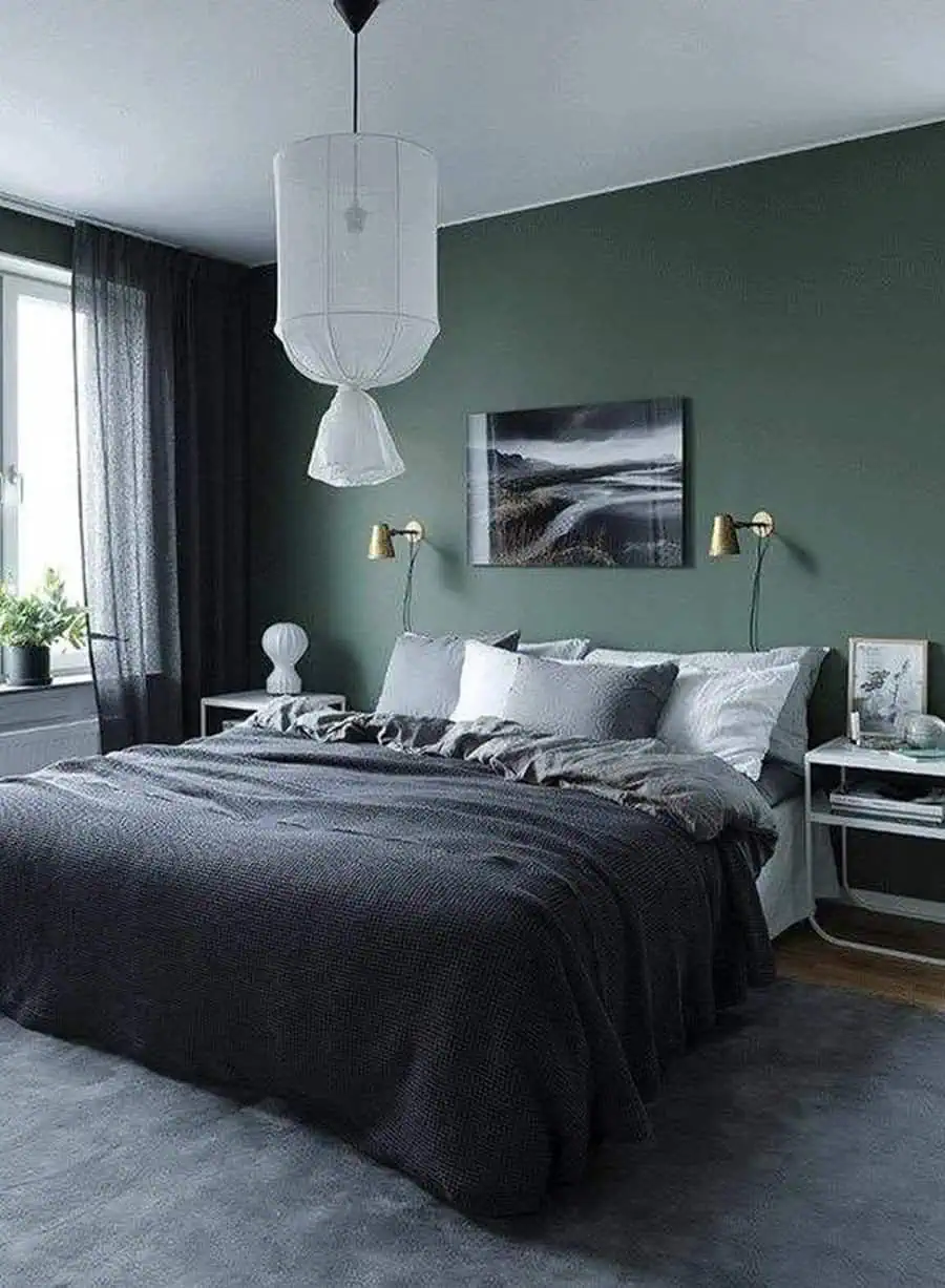 Modern bedroom with dark green walls, gray bedding, and minimalist decor for couples.