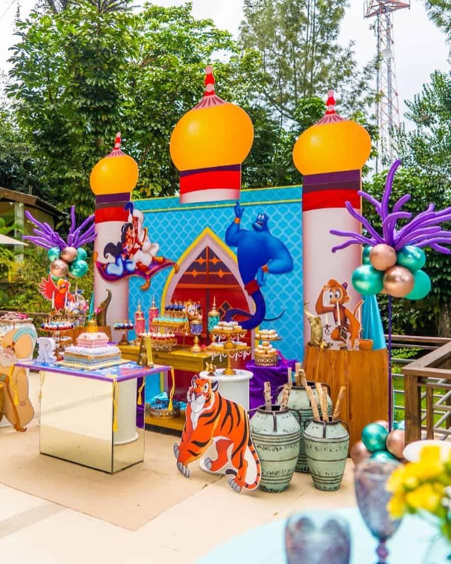 Aladdin-themed birthday party with palace backdrop, character cutouts, and dessert table.