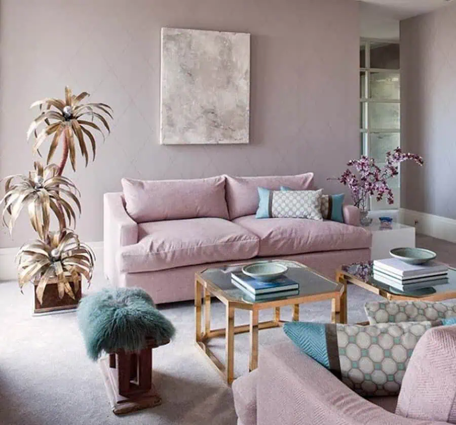 Living room with dusty rose furniture, teal accents, gold decor, and soft lavender walls.