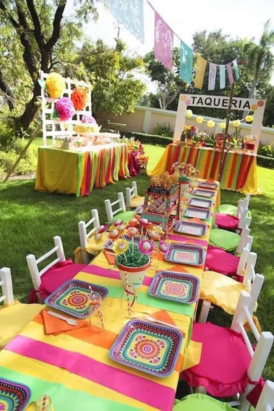 Fiesta-themed outdoor party with colorful table settings and festive decorations.