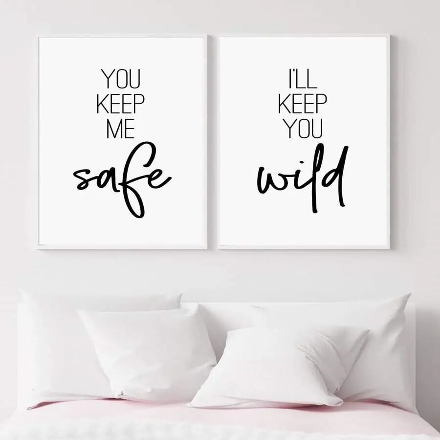 White bedroom with romantic quote wall art and soft pillows for a cozy couple's retreat.