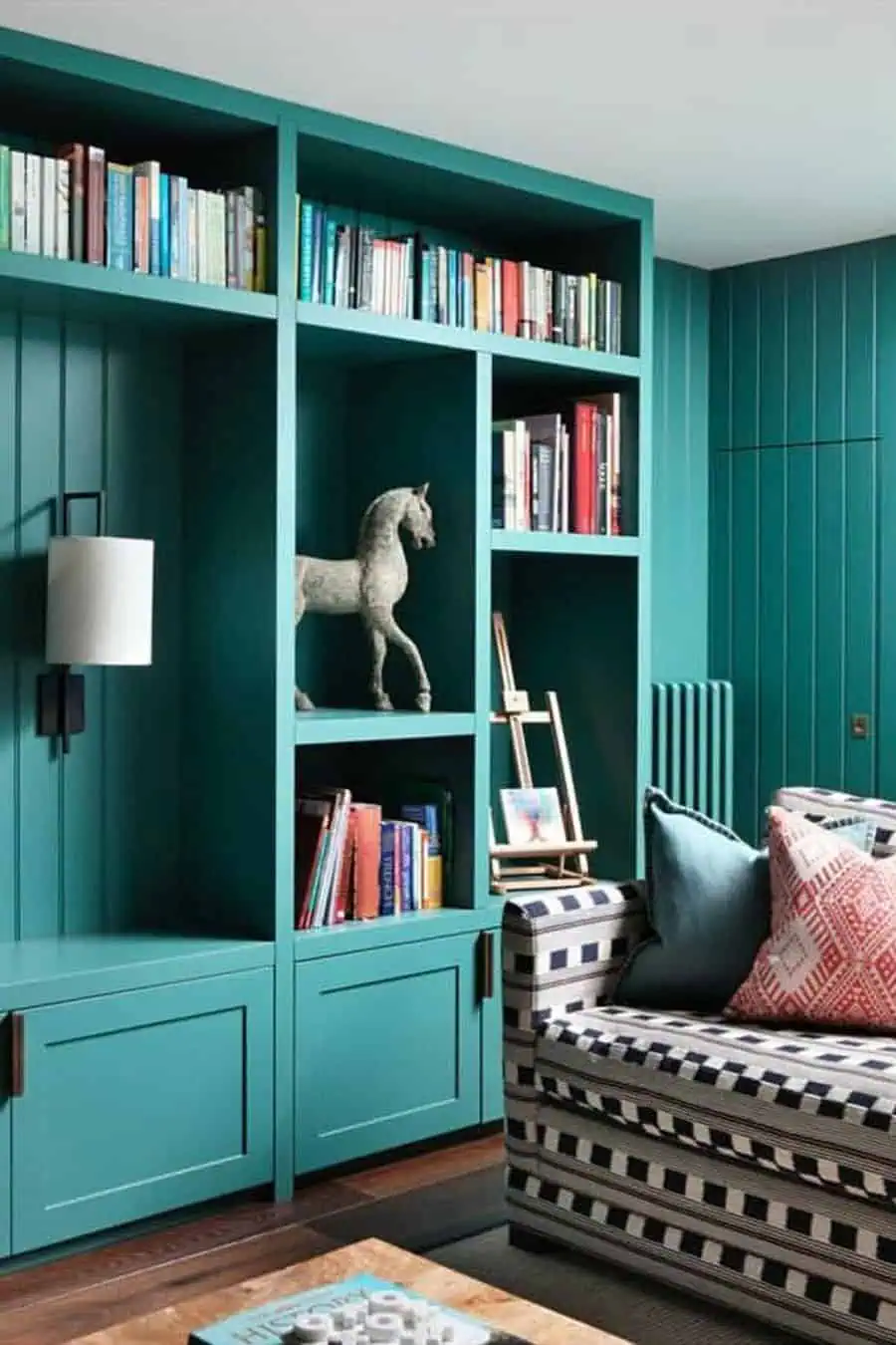 Teal bookshelf adds bold color and practical storage.