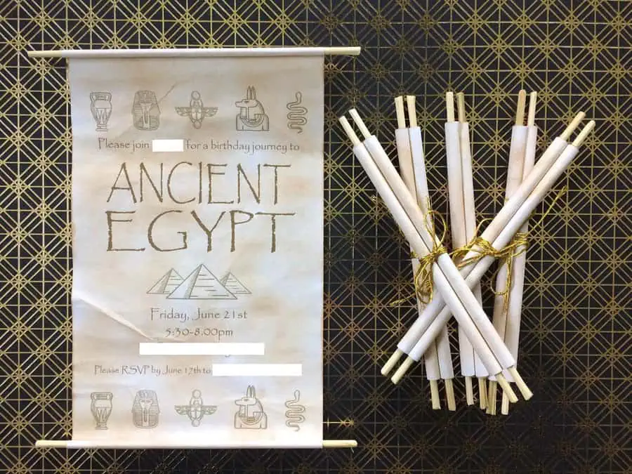 Handmade Ancient Egypt-themed birthday party invitations designed as scrolls with hieroglyph-inspired symbols.