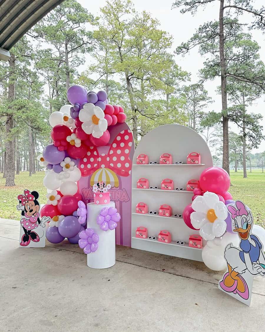 Minnie Mouse-themed party with pink balloons and fun decor.