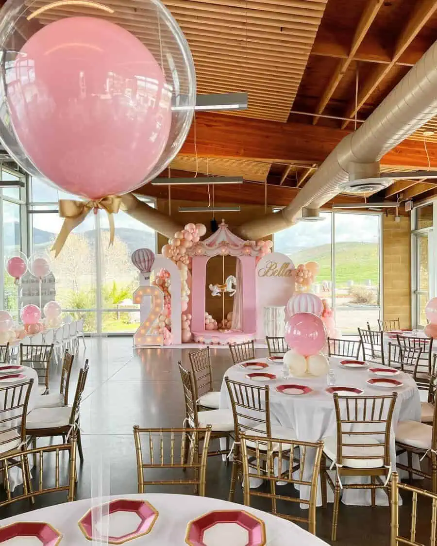 Carousel-themed birthday with pastel pink and gold. Features a carousel backdrop and "2" marquee light. 