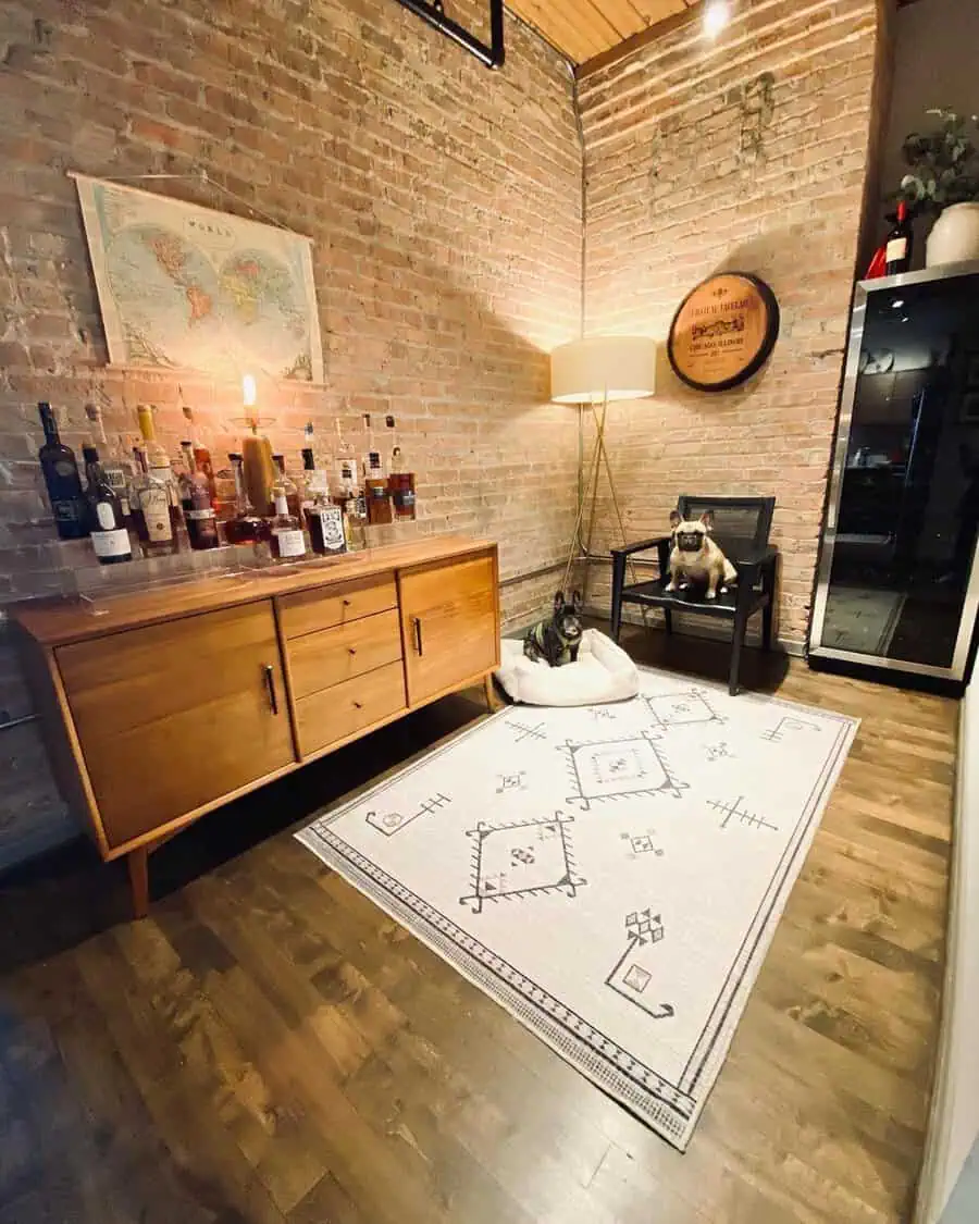 Laid-back den with exposed brick walls, wooden cabinet, cozy rug, and soft ambient lighting.