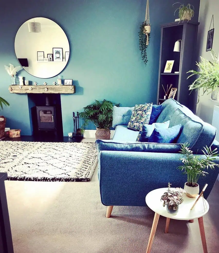 Bright teal living room with layered blue hues, natural wood accents, and greenery for a fresh, vibrant look.