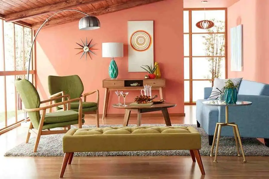 Eclectic living room with mid-century furniture, coral walls, and modern decor accents.