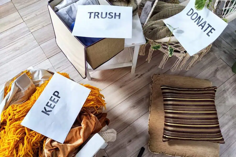 Boxes labeled "Keep," "Trash," and "Donate" with assorted items for decluttering.