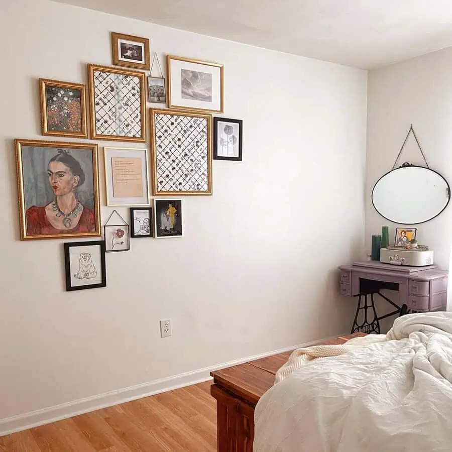 Eclectic bedroom featuring a gallery wall of framed art and a vintage purple vanity.