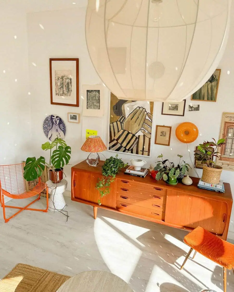 Eclectic living room with mid-century furniture, plants, and vintage art on walls.