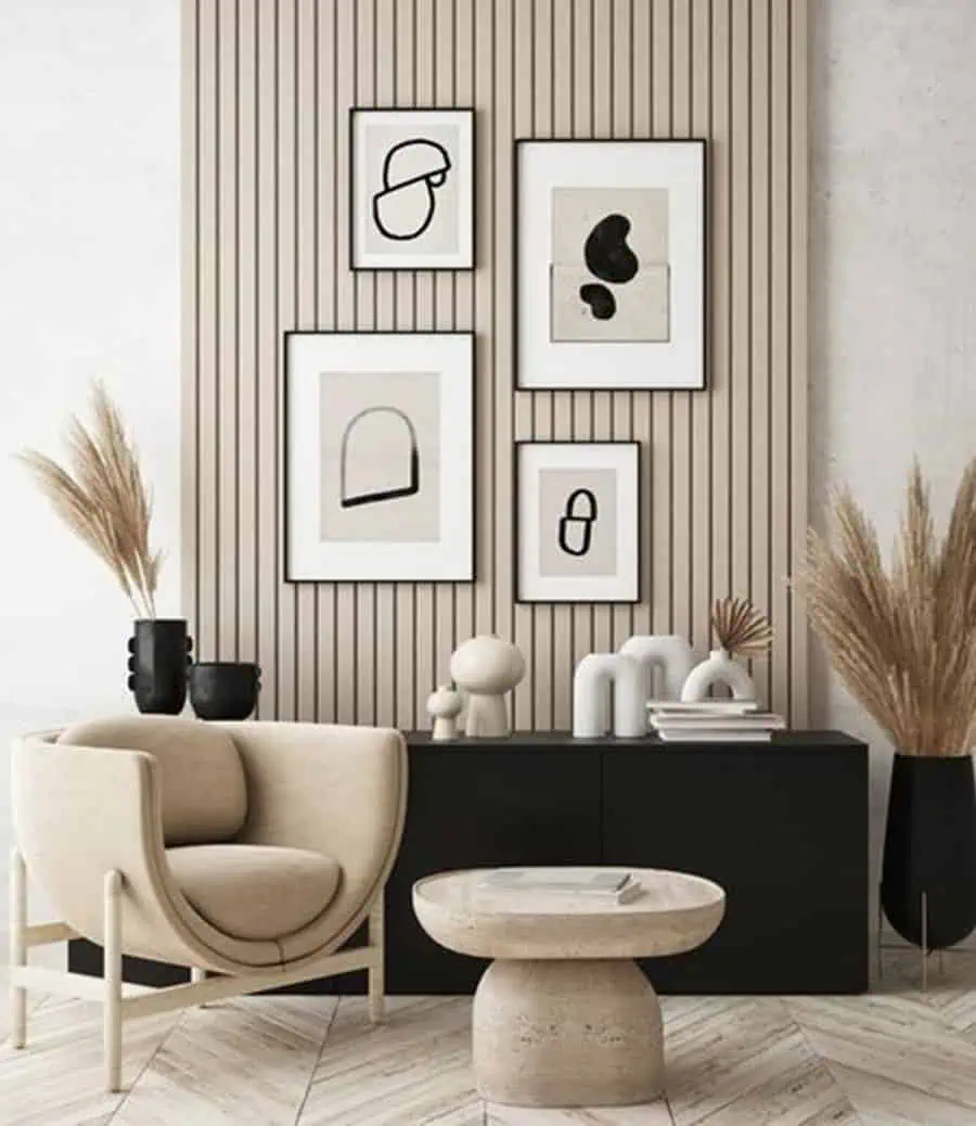 Modern studio apartment with abstract wall art, neutral tones, and sleek minimalist furniture.