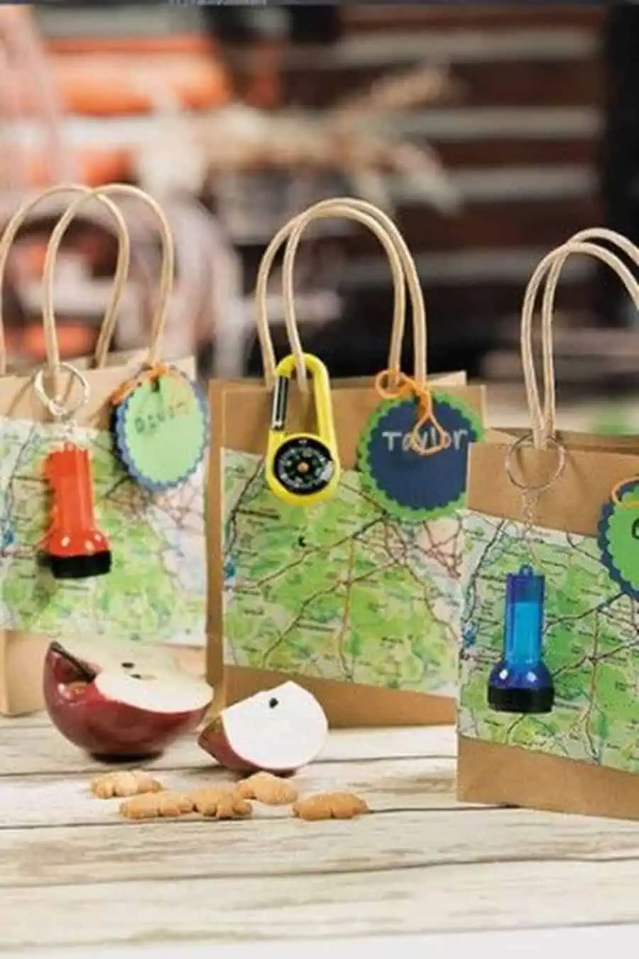 Adventure-themed party favor bags with maps, flashlights, and small compasses.