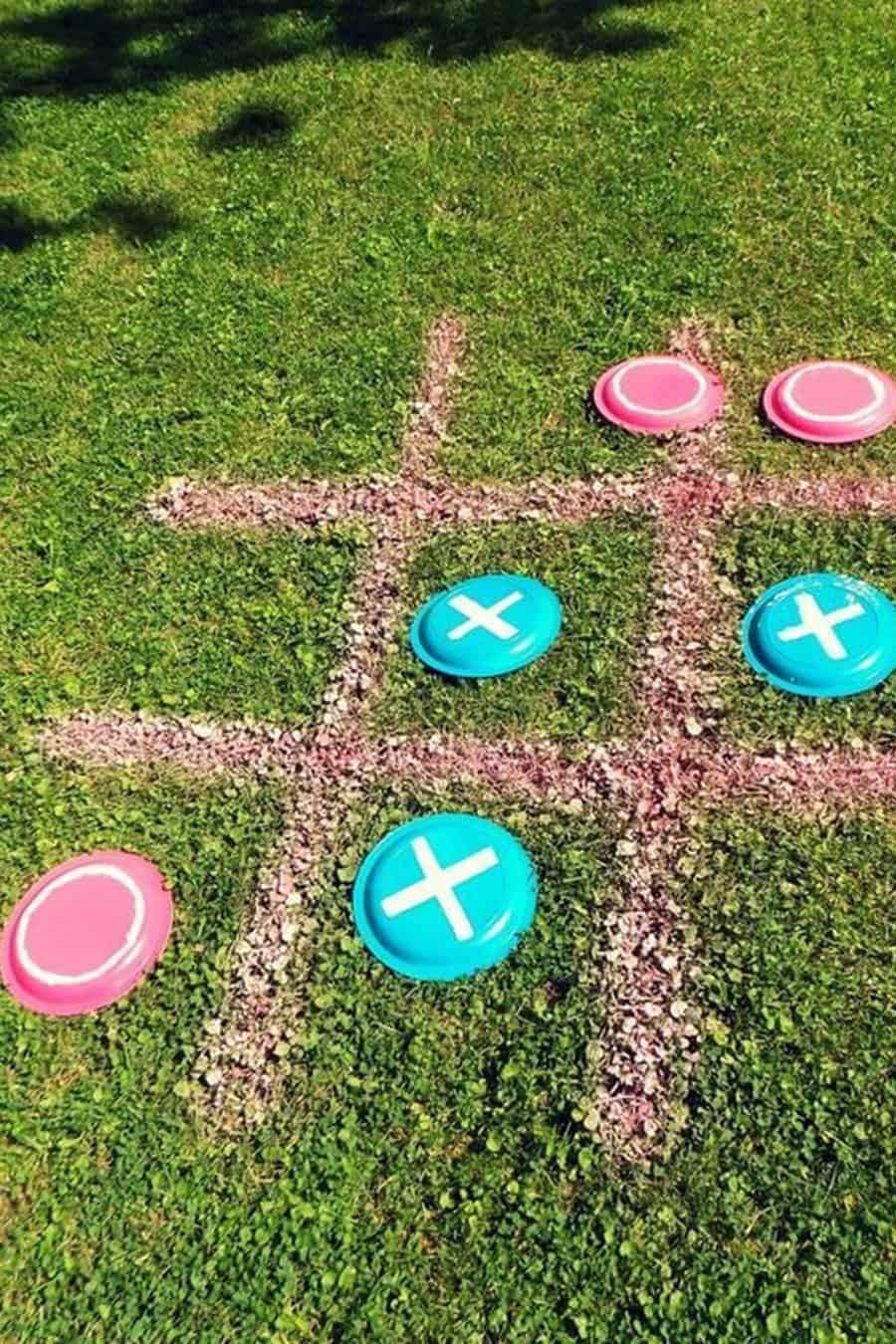 Outdoor tic-tac-toe game using colorful frisbees for a birthday party.