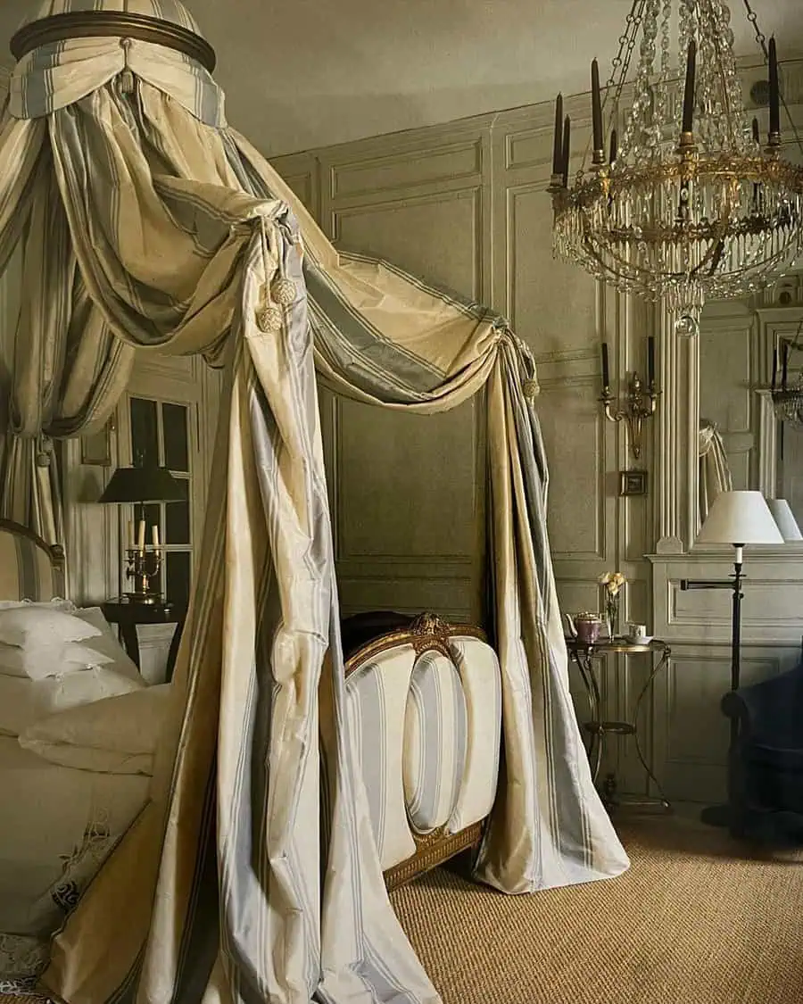 Elegant bedroom with canopy bed, draped curtains, and crystal chandelier for a romantic vibe.