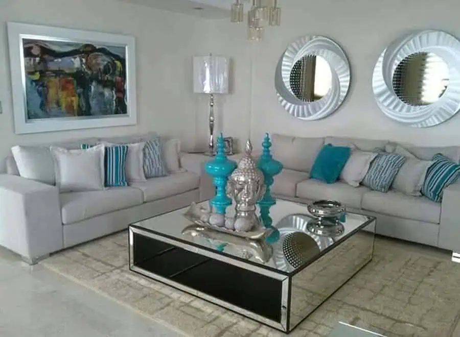 Silver accents paired with teal accessories add a sophisticated and modern touch to this living room.