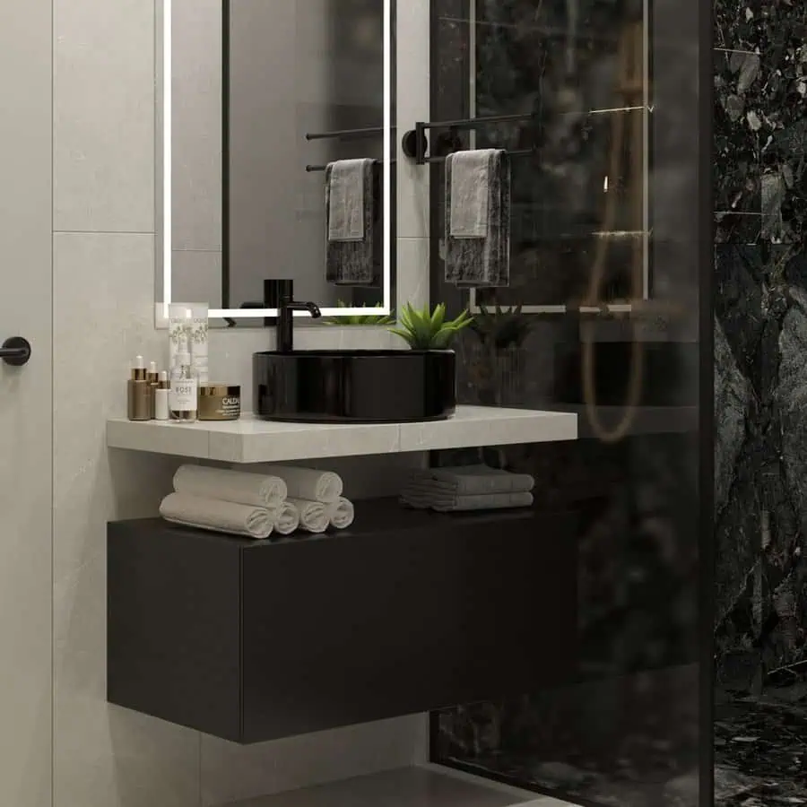 Master small luxury bathroom with black marble walls, illuminated mirror, modern vanity, and sleek fixtures.