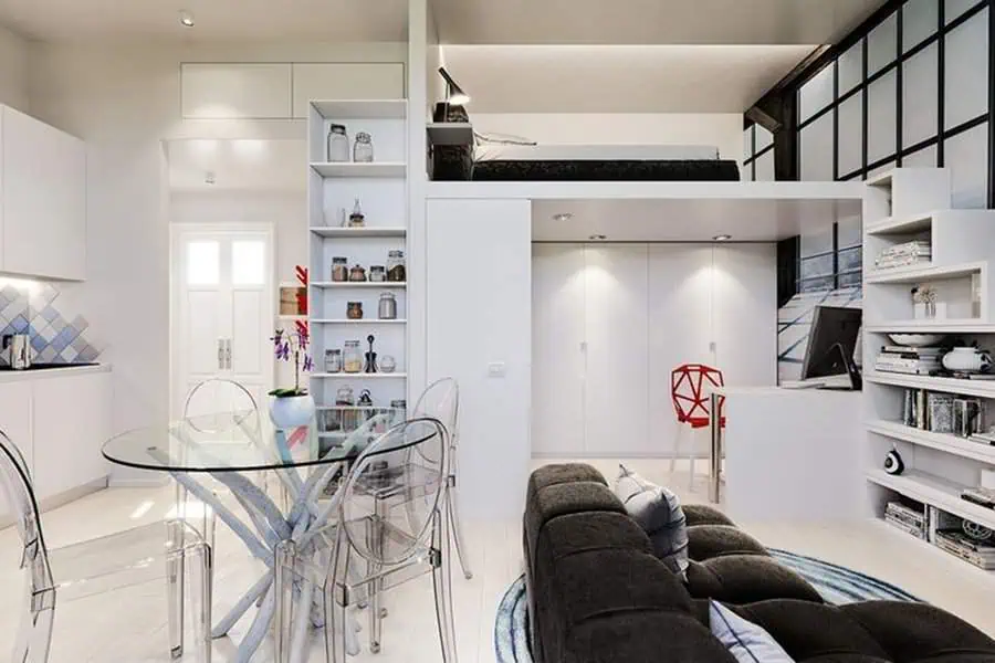 Modern studio apartment with loft bed, built-in shelves, and sleek multifunctional furniture.