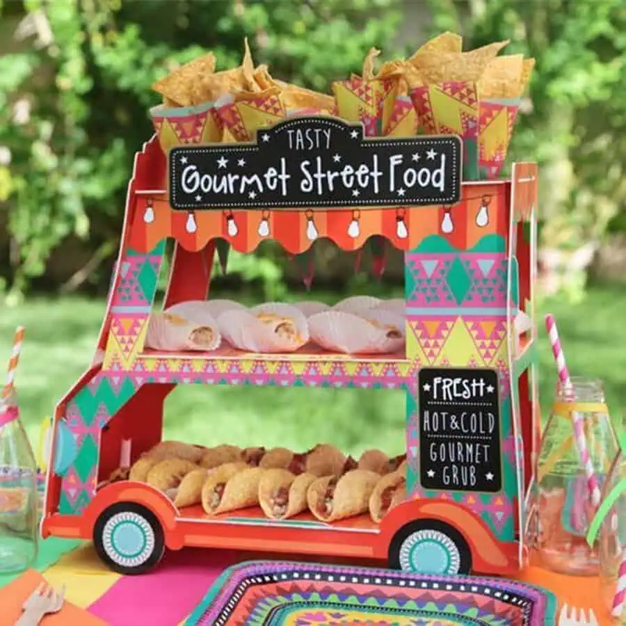 Colorful taco-themed food display at a festive outdoor birthday party.