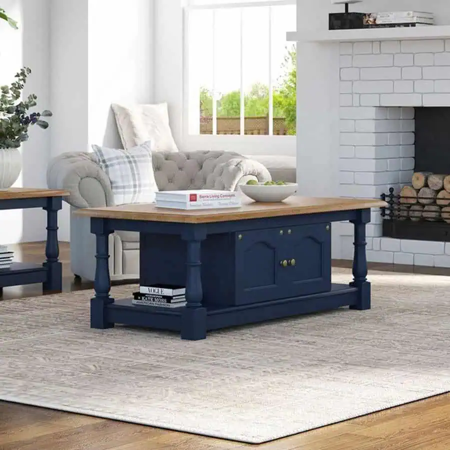 Teal living room with a navy and wood coffee table adding charm to the cozy setup.