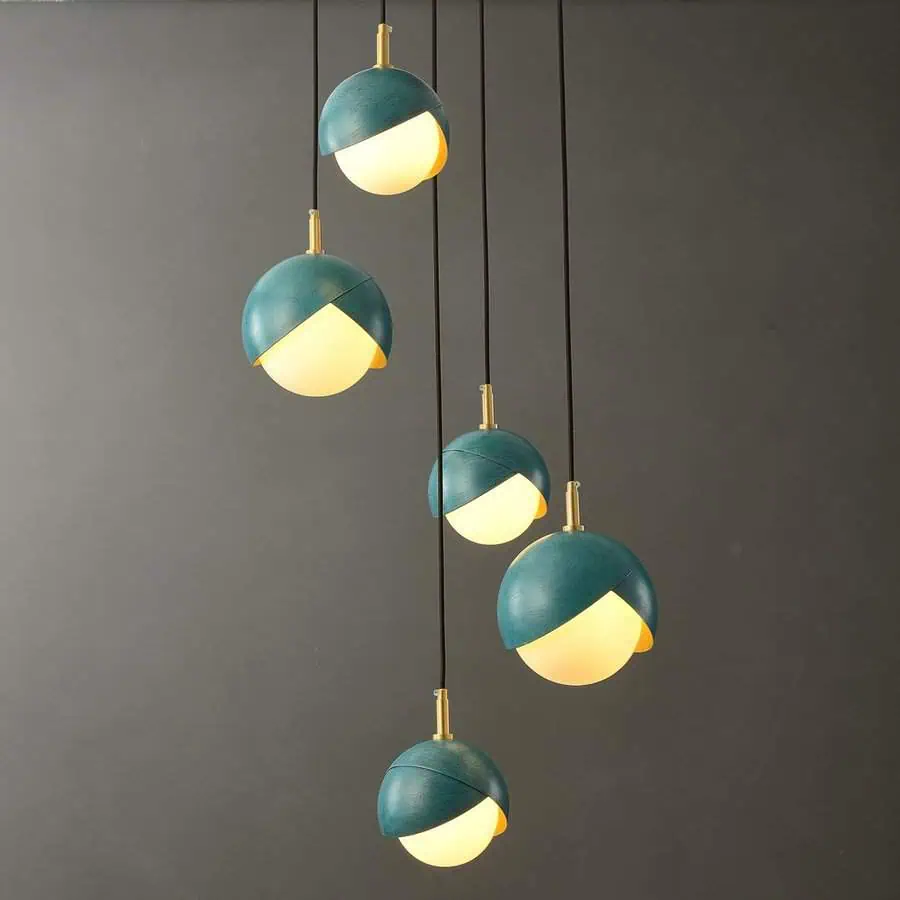 Teal bloom pendant lights with a modern spherical design, perfect for adding elegance to a living room.