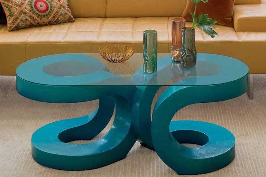 This striking teal coffee table with a glass top adds a bold and modern flair to the living room.