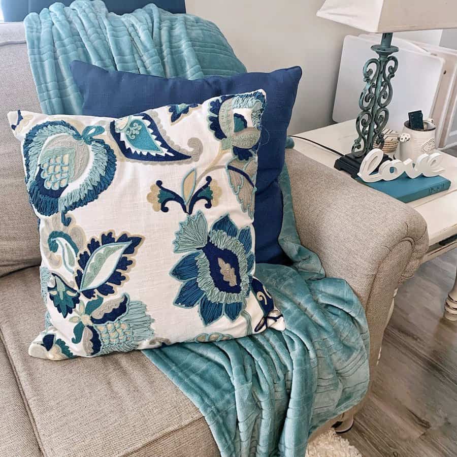 Cozy teal and floral accents add warmth to this inviting living room setup.