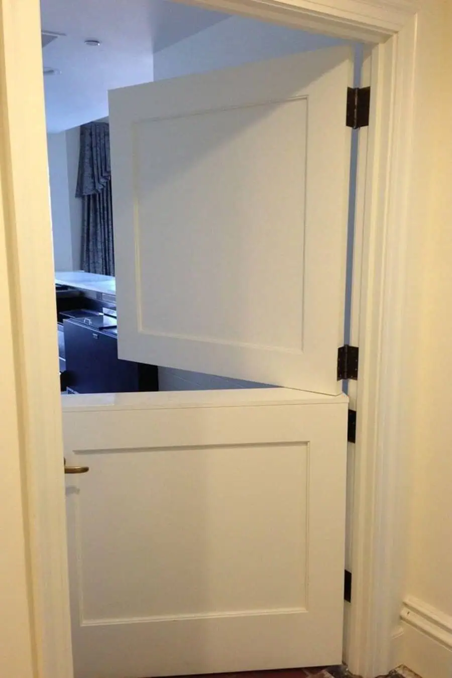 Classic white Dutch door with simple panel design, open to reveal a cozy interior space.