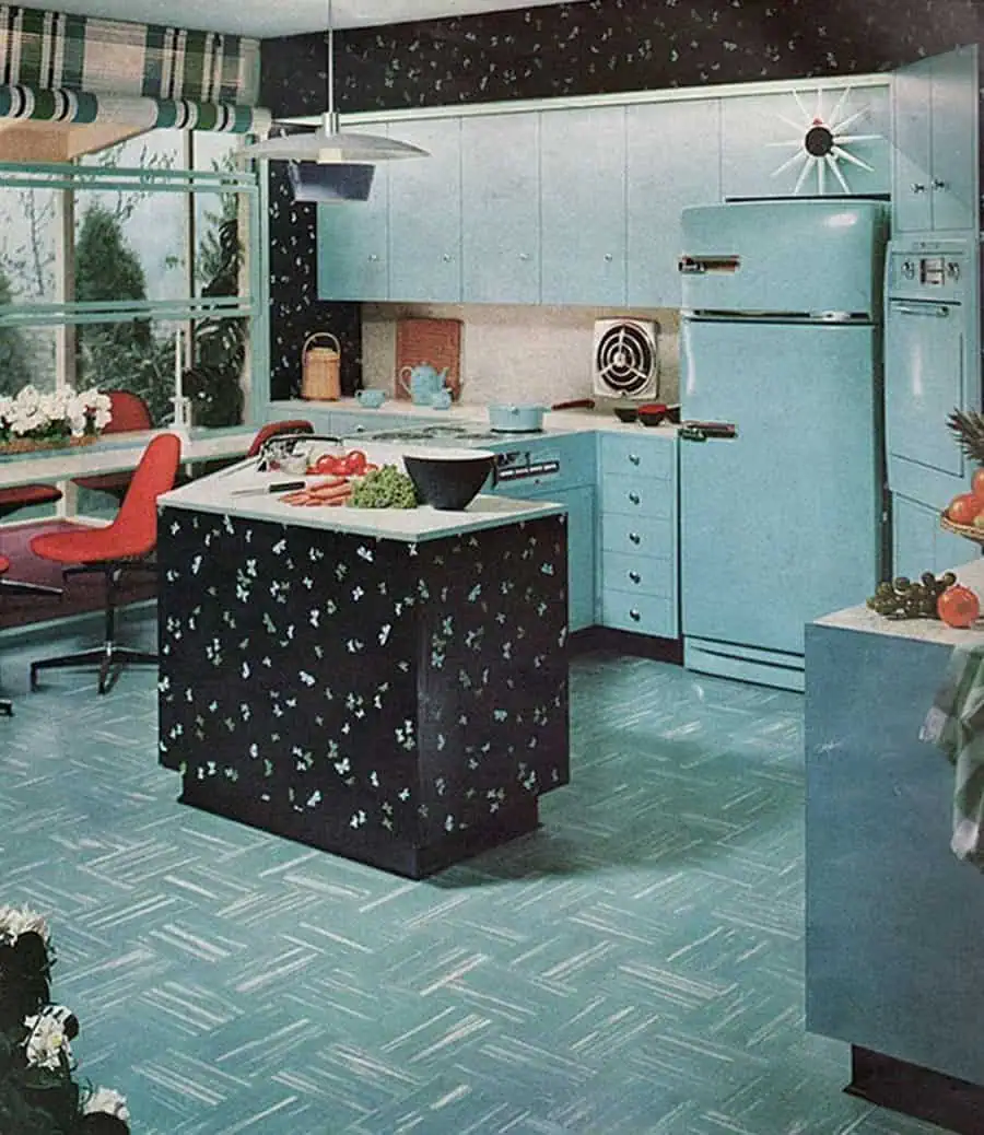 1950s kitchen with turquoise cabinets, patterned island, and retro appliances.