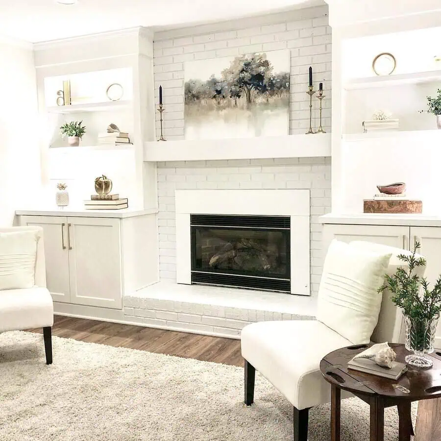 Warm fireplace with built-in shelves and stylish den decorations.