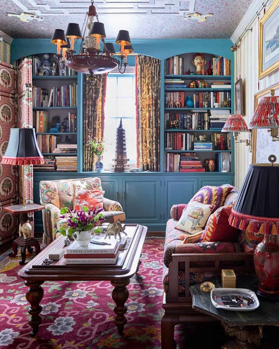 Vibrant living room with patterned rugs, colorful furniture, bookshelves, and decorative accents.