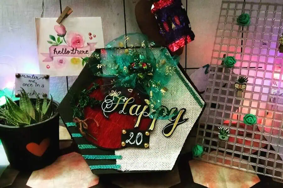 Handmade decorative "Happy 20" gift display with plants and artistic details.