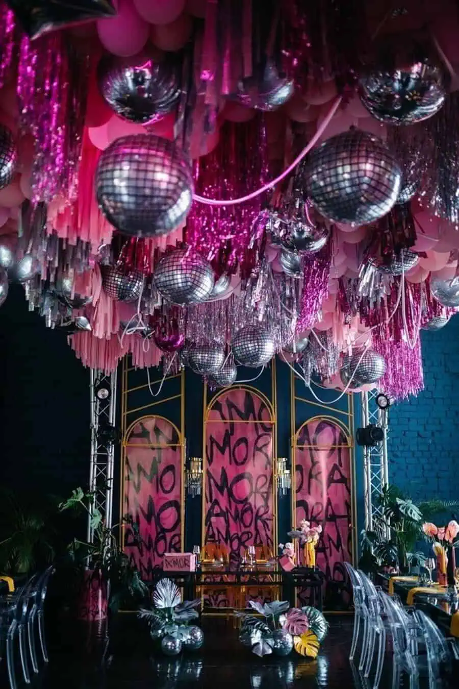 Vibrant 40th birthday celebration with disco balls, pink tinsel, and bold "Amor" decor accents.