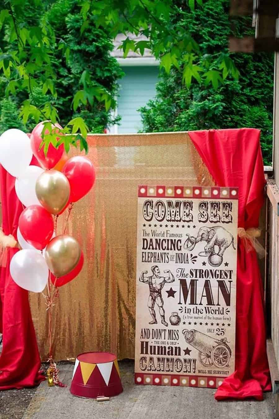 Circus-themed 40th birthday setup with vintage poster, red curtains, and gold and red balloons.