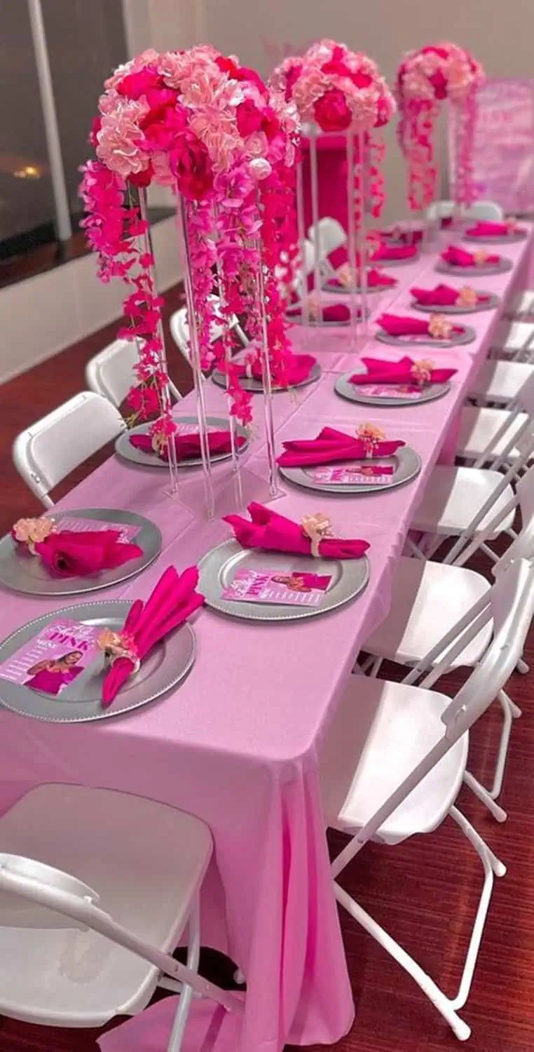 Vibrant pink-themed table setting with cascading floral centerpieces for a glamorous 40th birthday celebration.